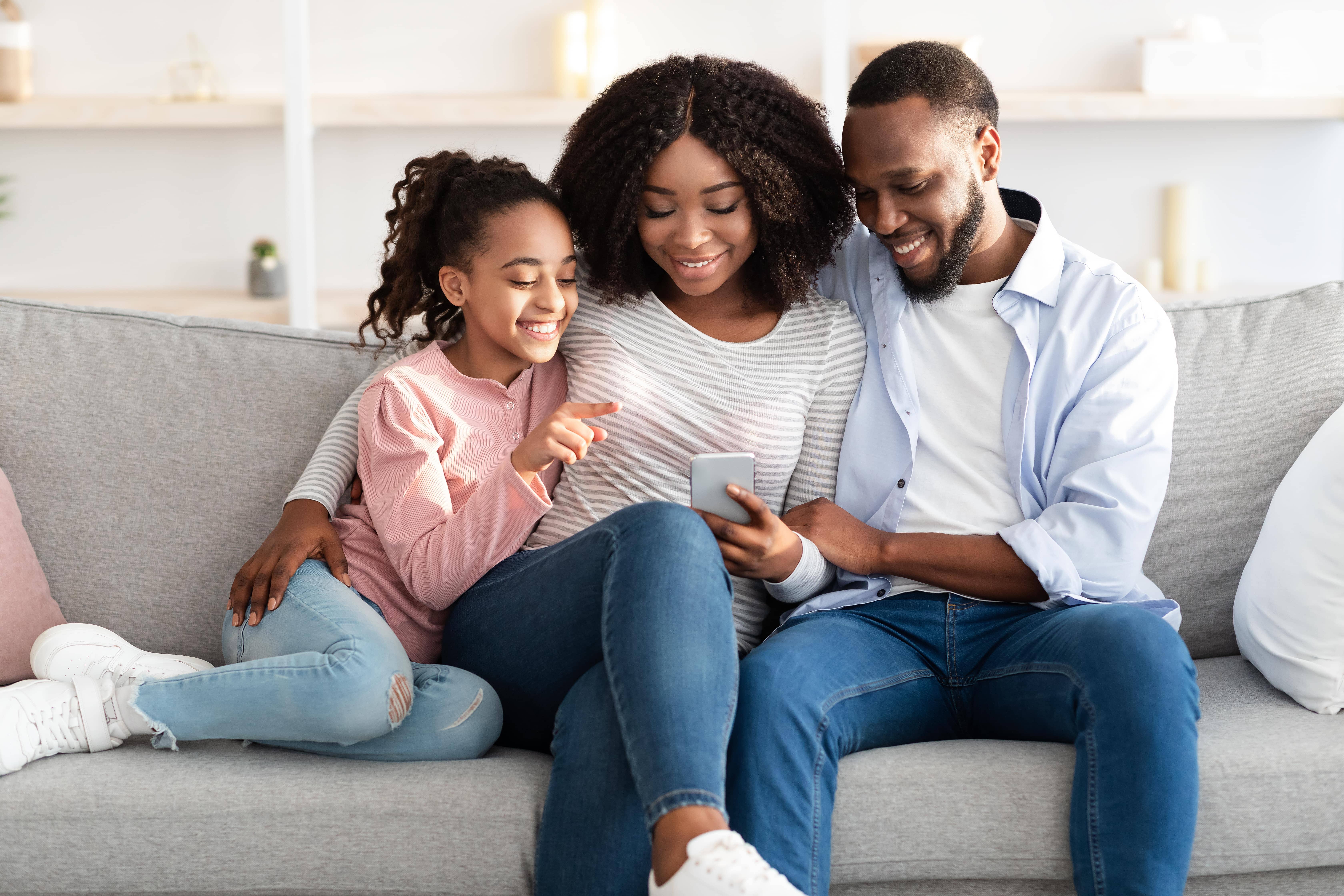 A parent using the phone to send campus money